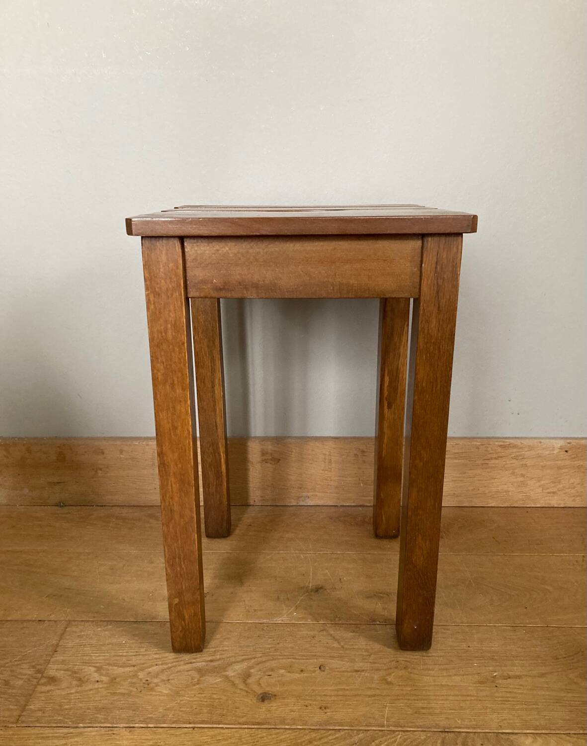 Wooden stool with central grip, quadripod base, 20th century