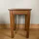 Wooden stool with central grip, quadripod base, 20th century