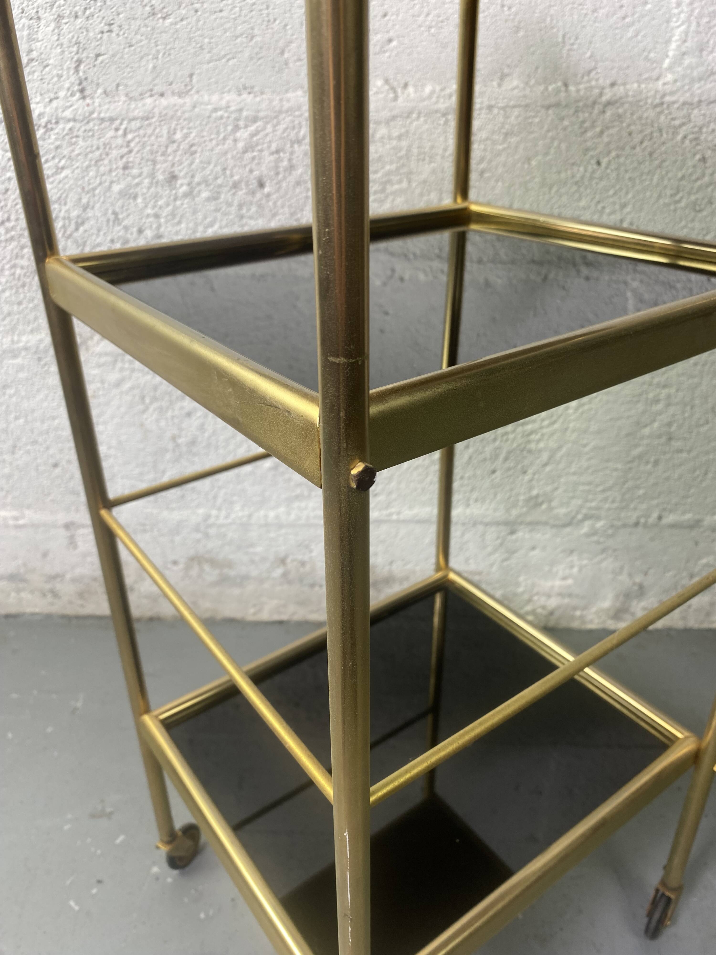 Small rolling trolley in brass and black plastic