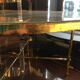 Table basse en bronze doré, verre façon miroir doré, circa 1940