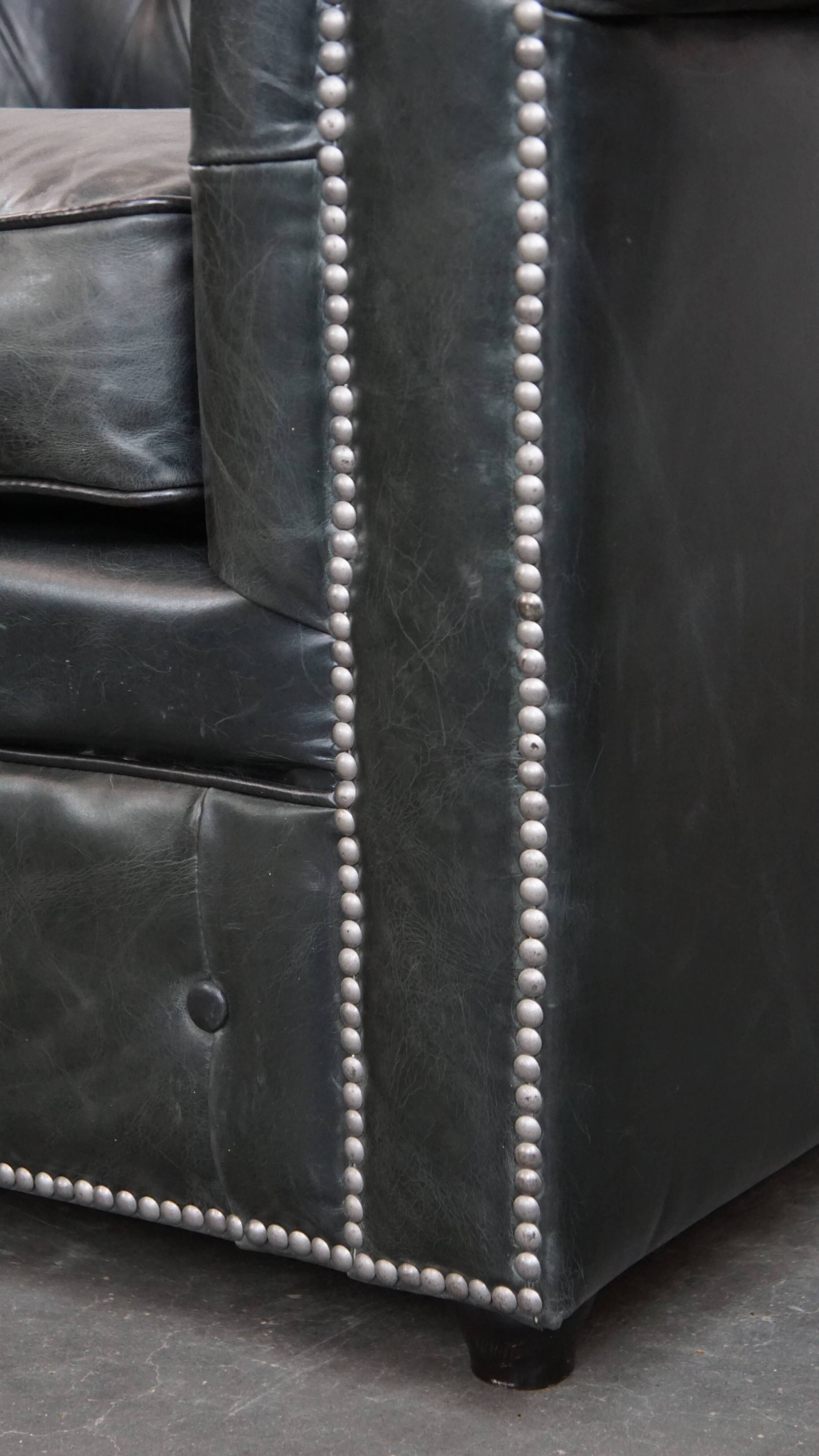Black Chesterfield armchair made of grained cowhide leather