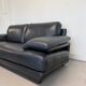 Two-seater Natuzzi sofa in navy blue leather.