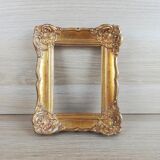 Patinated golden frame in wood and stucco