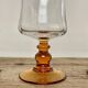 6 small amber-stemmed glasses