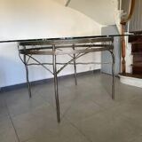 Round table with glass top and ornate metal base