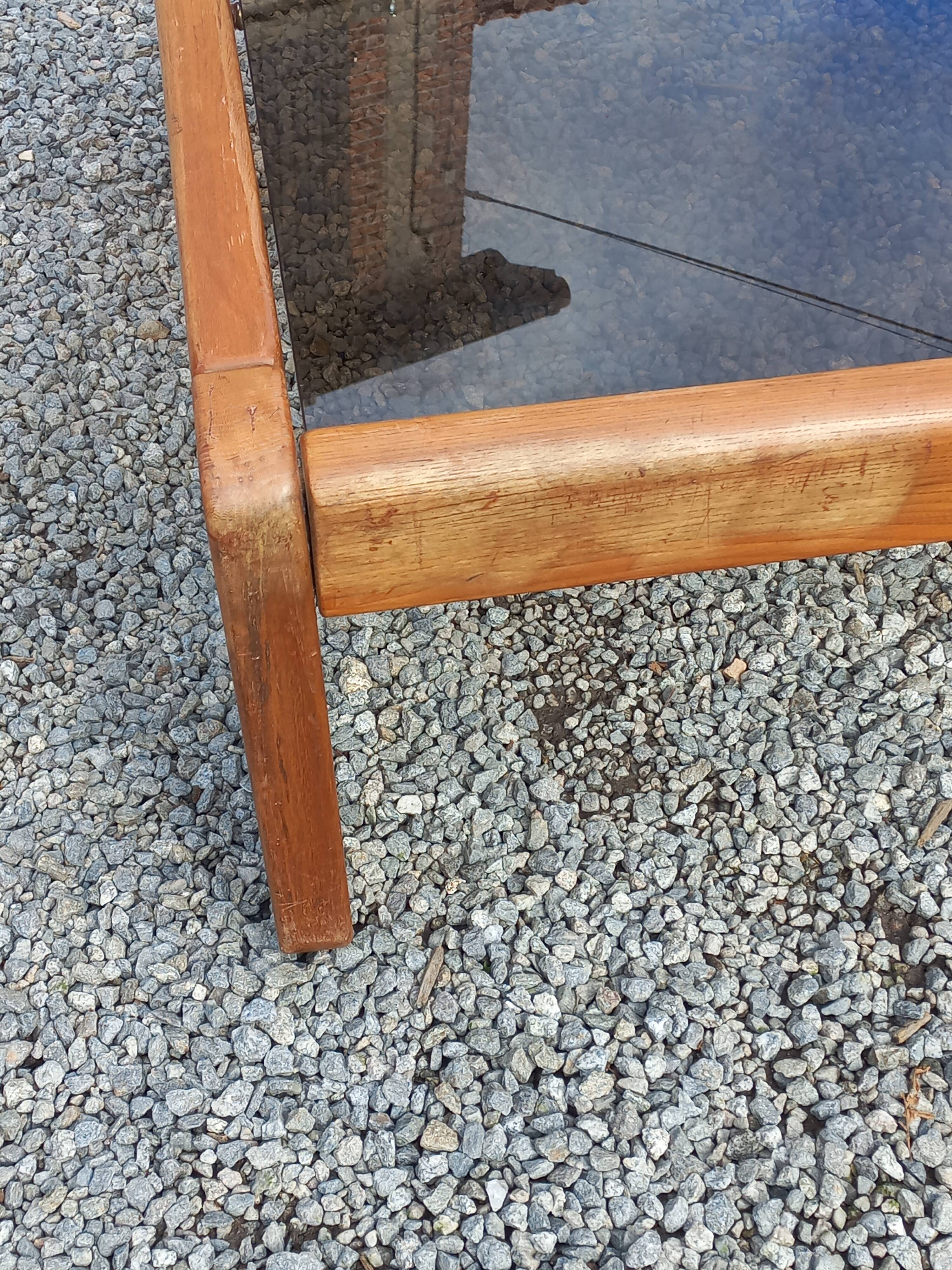 Coffee table from Regain in solid elm with a smoked glass top.