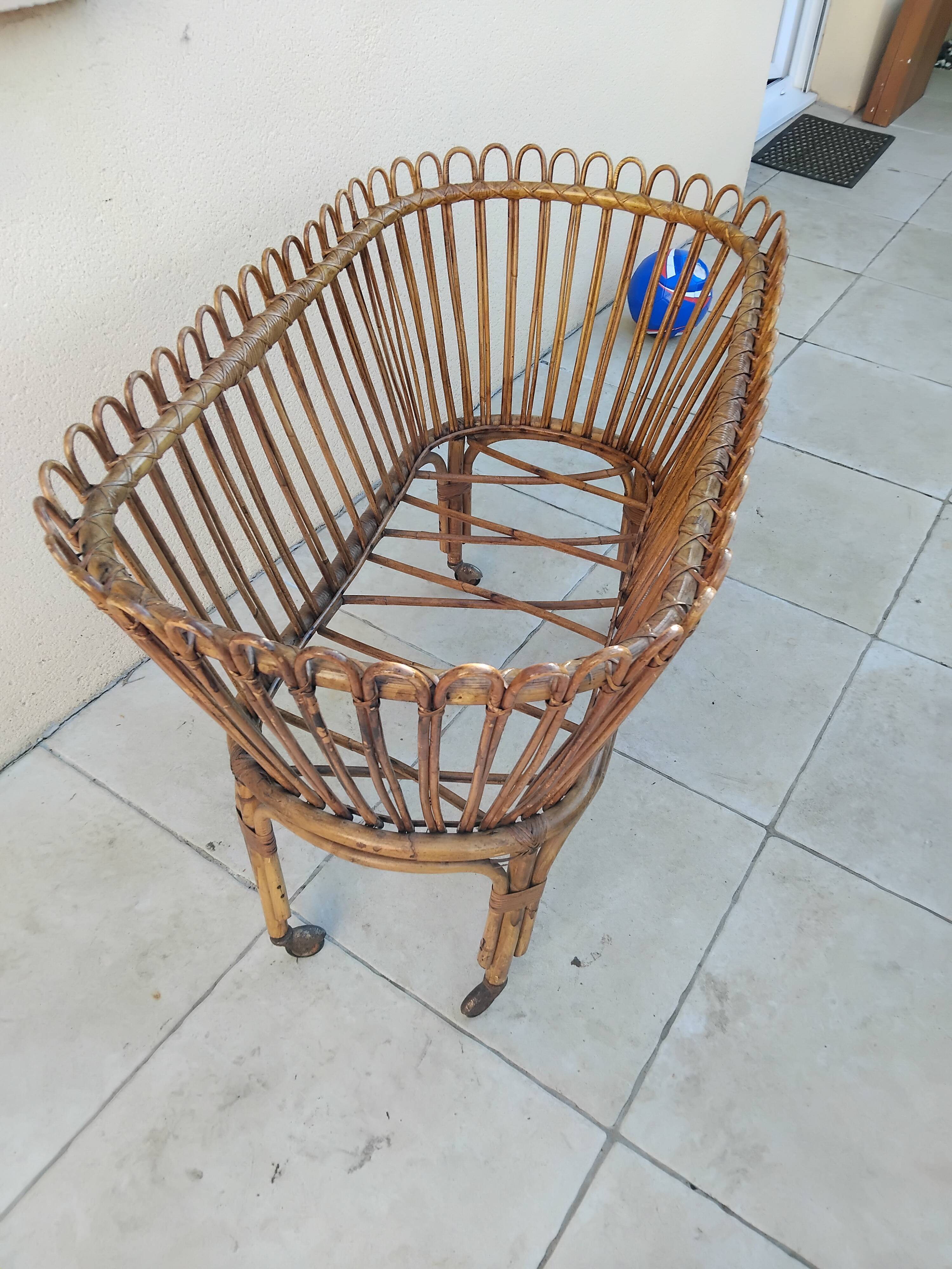 Vintage rattan bed on wheels cradle