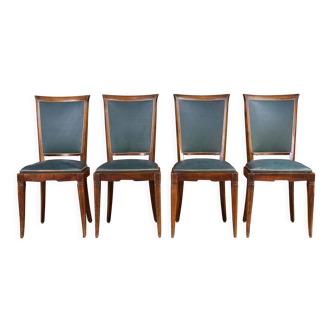 Ensemble art déco de quatre chaises en bois et similicuir vert jaguar, vers 1950