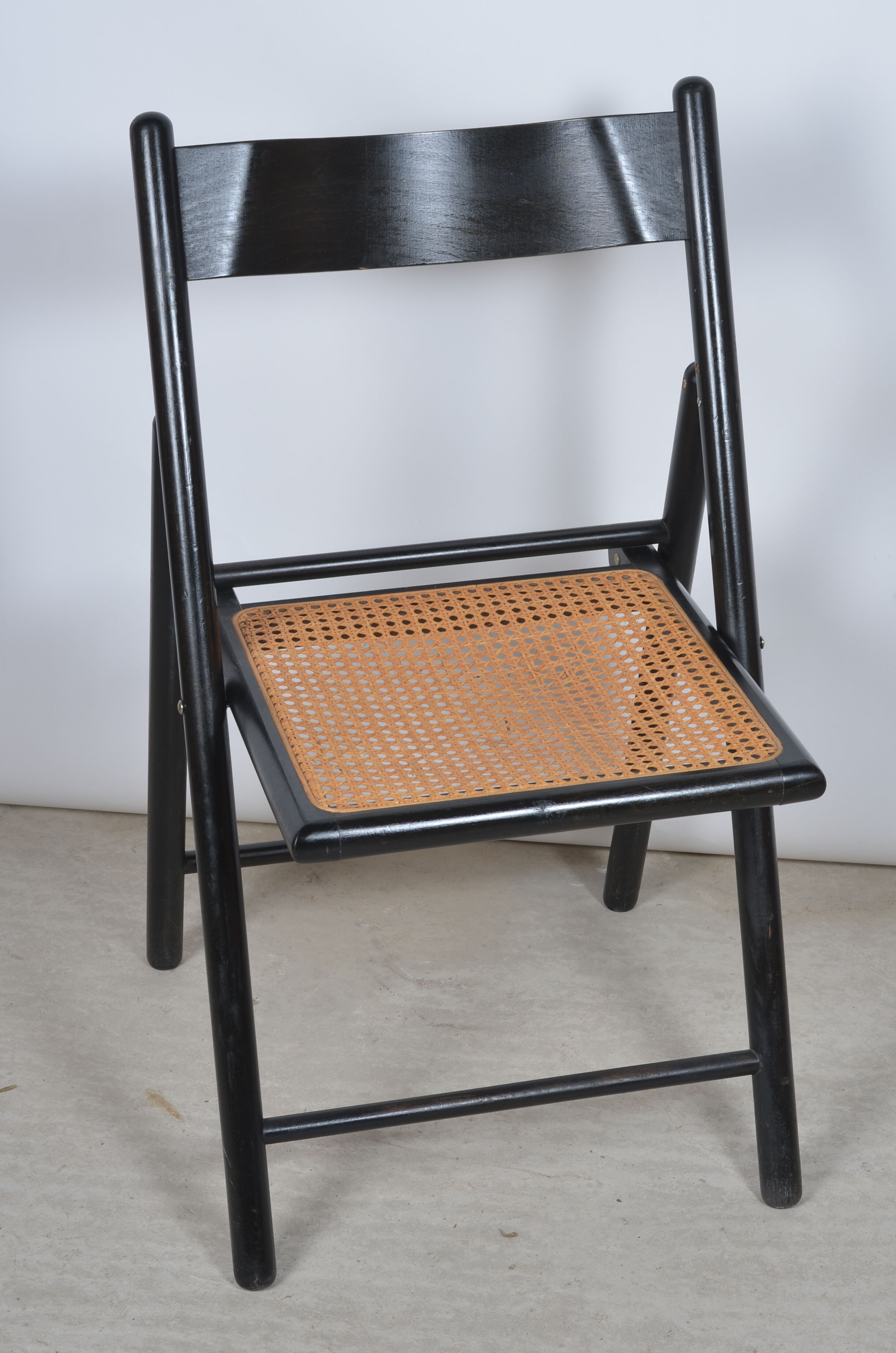 Folding chair seated in cannage