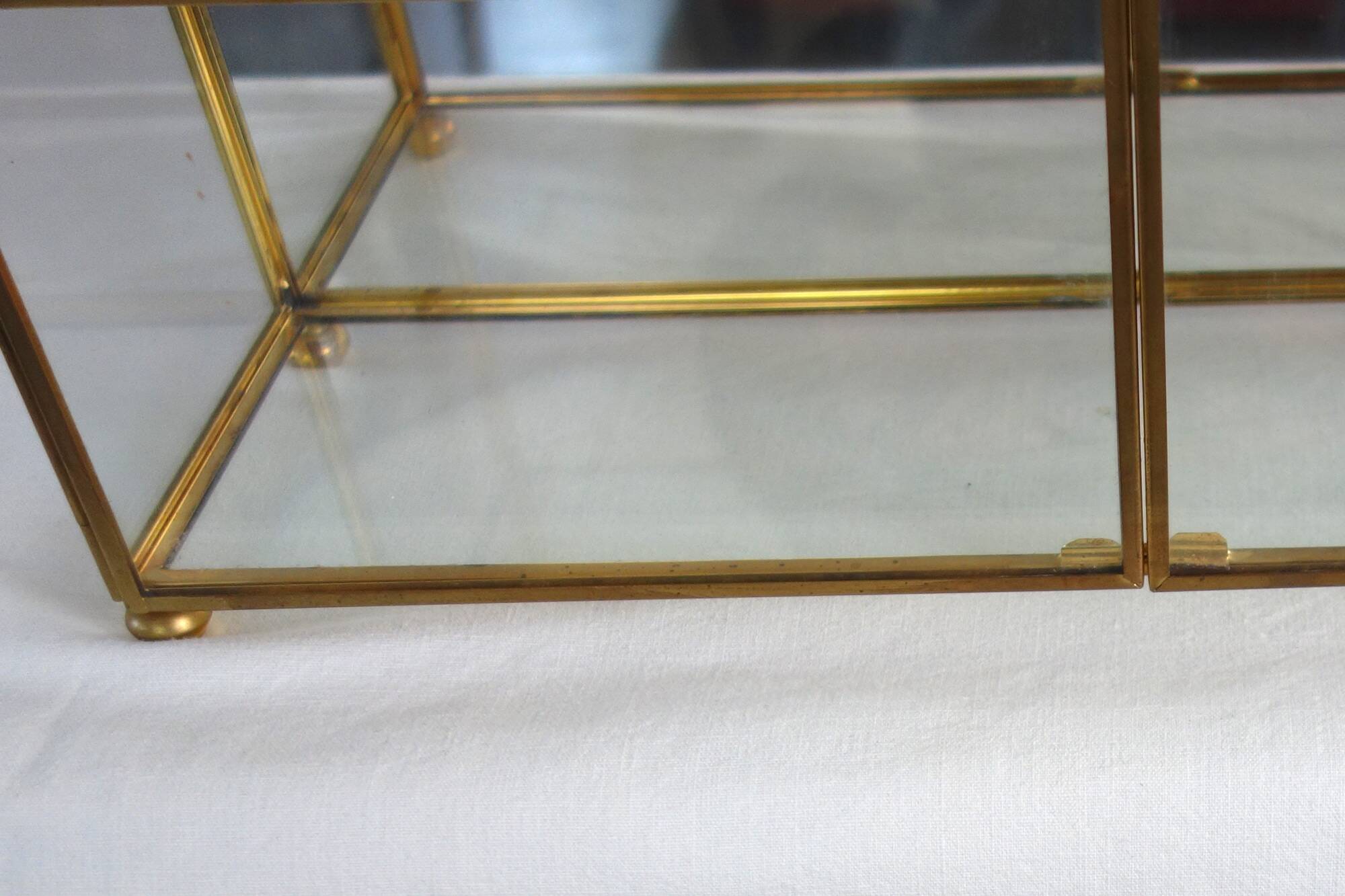 Pair of gilded brass, glass, mirror display cases from the 60s