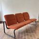 Strafor 3-seater bench, orange upholstery and sled base, 1970s.