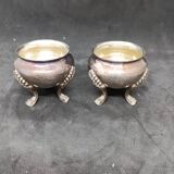 Pair of silver metal salt cellars with lion decor base
