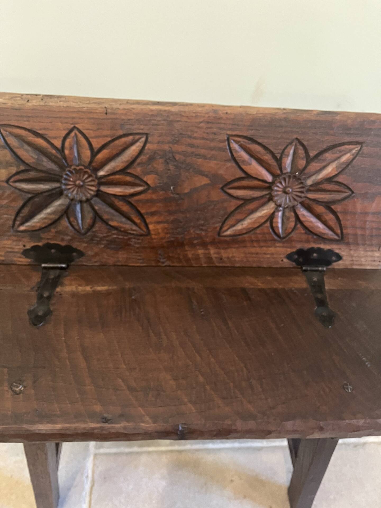 Small antique wooden bench with a folding backrest.
