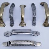 Seven art deco silver tone and brass handles