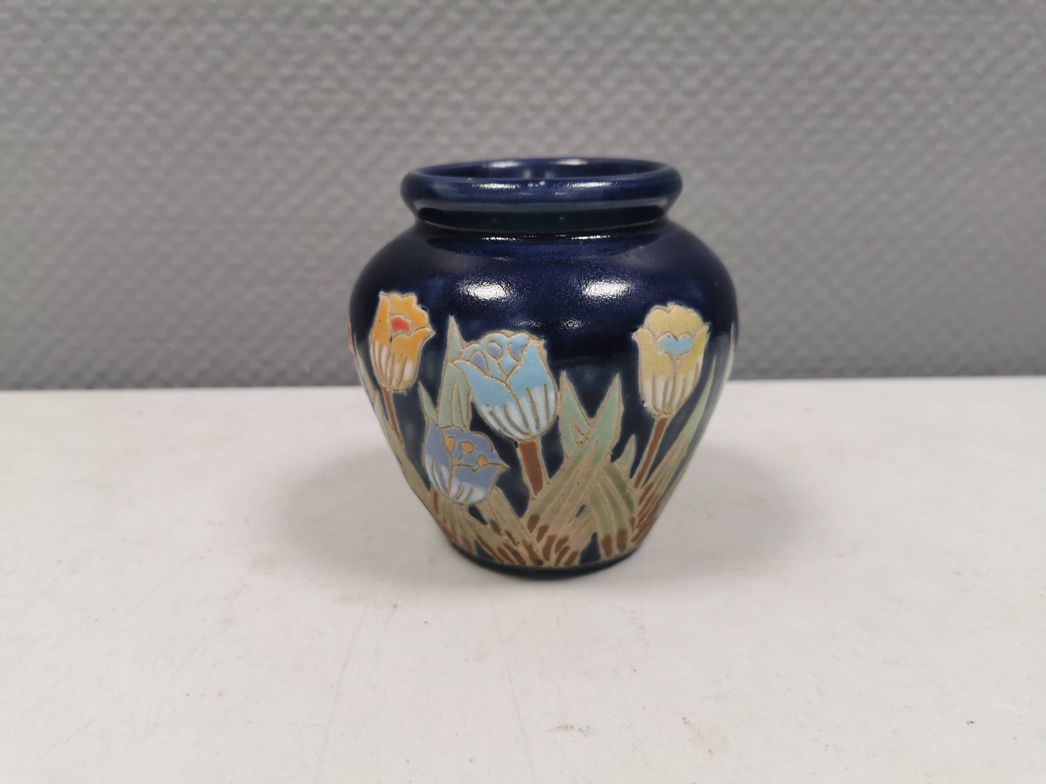 Small delicious blue ceramic vase with floral decoration. Sweden 1970s
