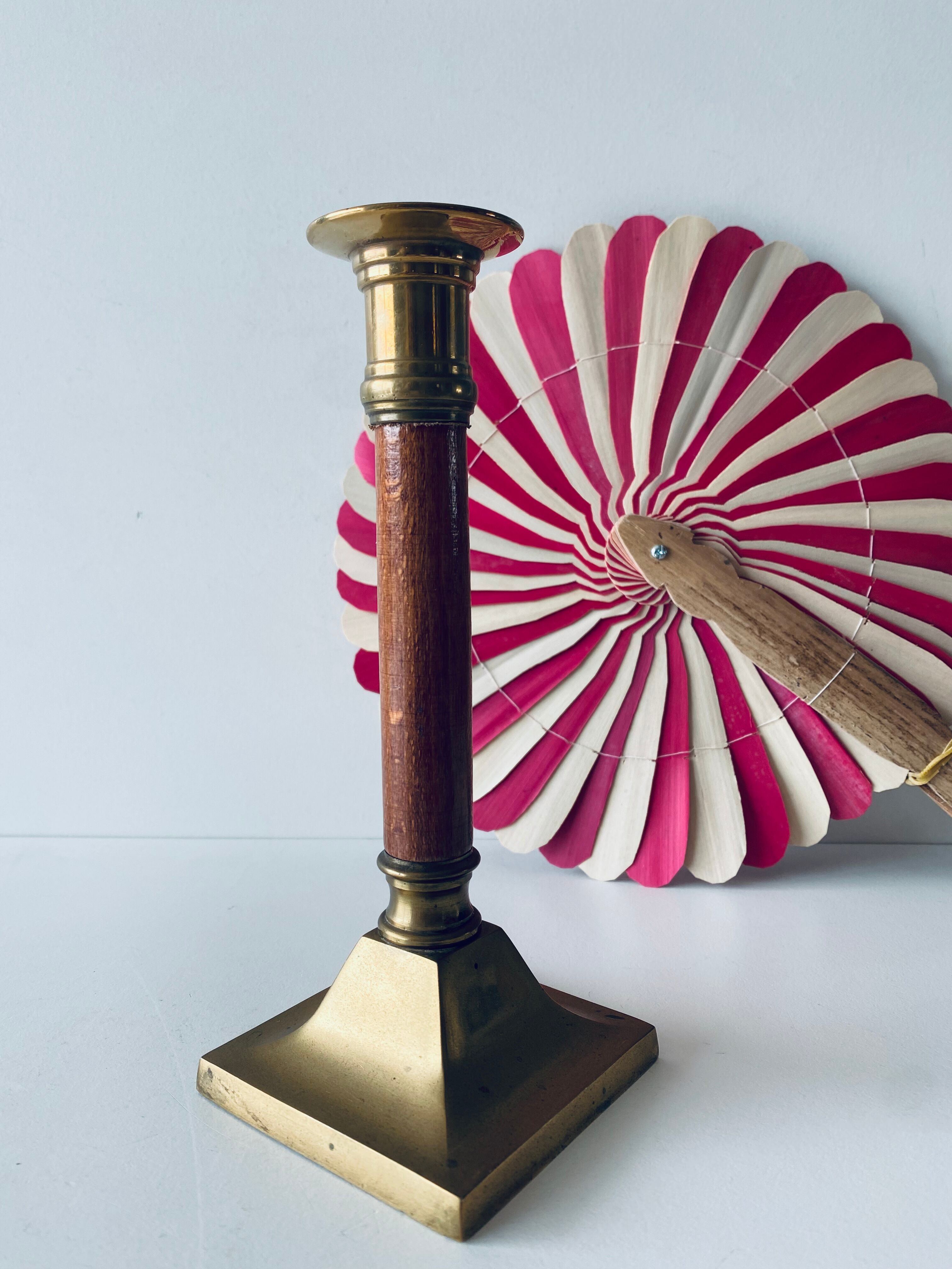 Old candle holder in brass and wood