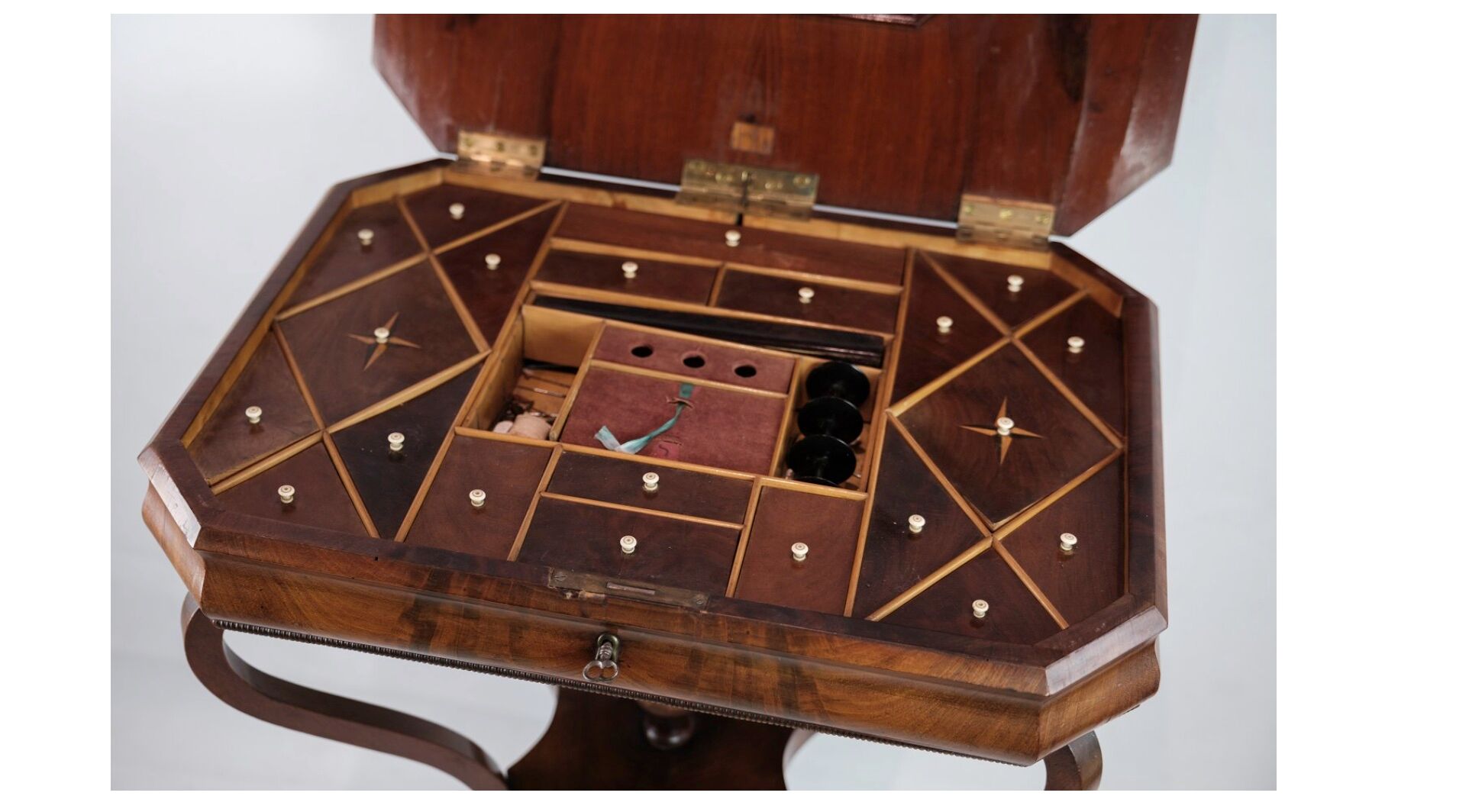 Antique mahogany sewing table on a pillar from around the year 1840s