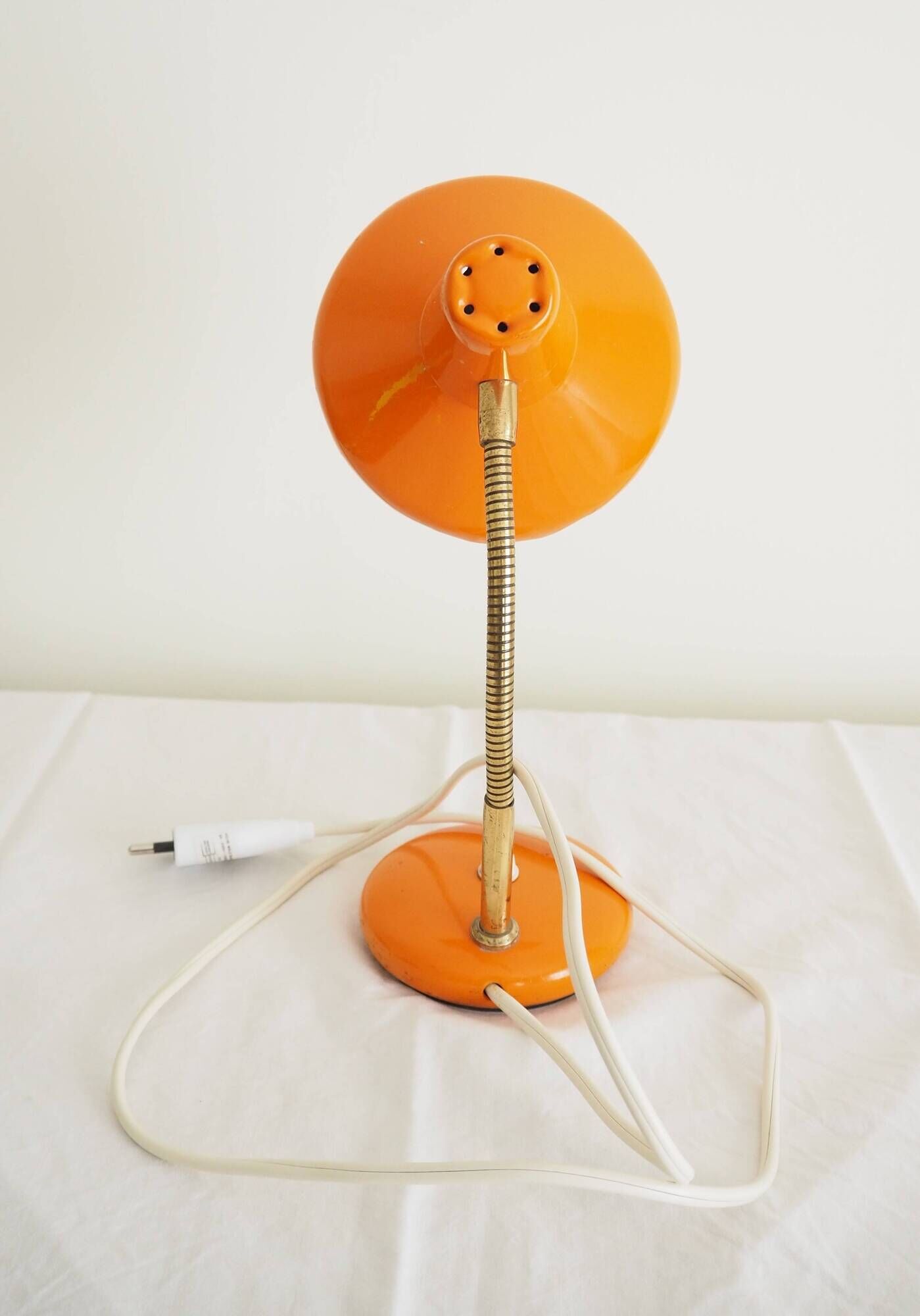 Orange colored metal desk lamp from the 1960s-1970s