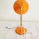 Orange colored metal desk lamp from the 1960s-1970s