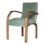 Art Deco armchair in wood and green fabric, living room armchair, interior decor.