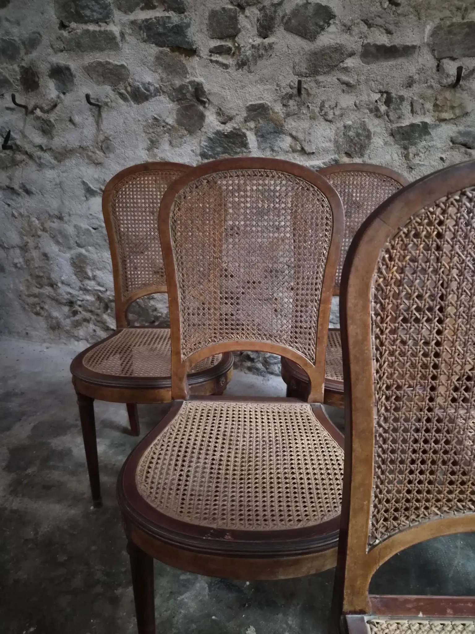 Set of 6 antique Louis XVI style dining chairs with caning.