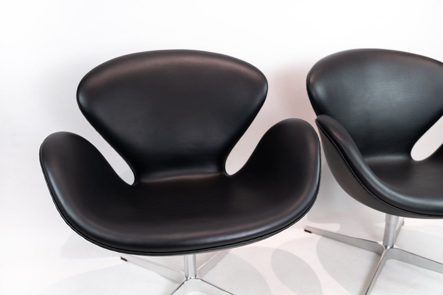A pair of Swan chairs, model 3320, designed by Arne Jacobsen in 1958