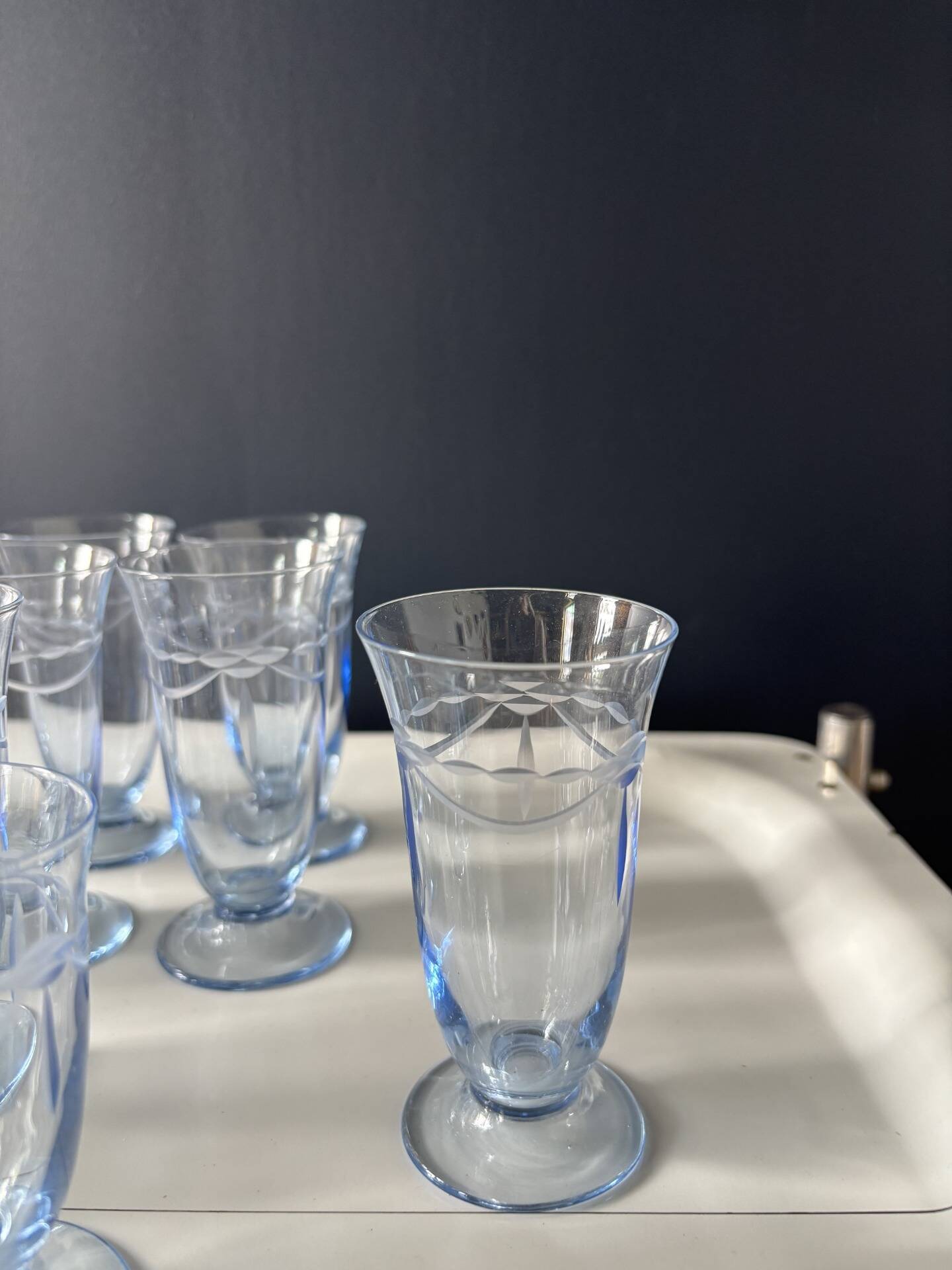 Set of 32 vintage glacier blue engraved stemmed glasses.