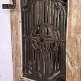 Chiseled teak door with openwork wrought iron panels