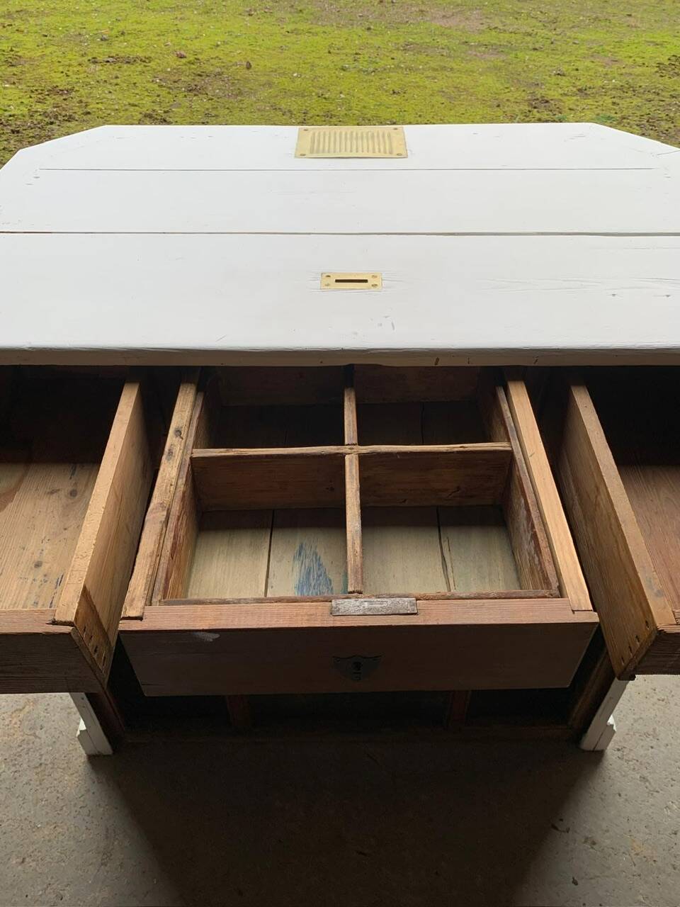 White counter with brass coin mechanism