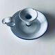 Old candle holder in white enameled metal