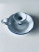 Old candle holder in white enameled metal