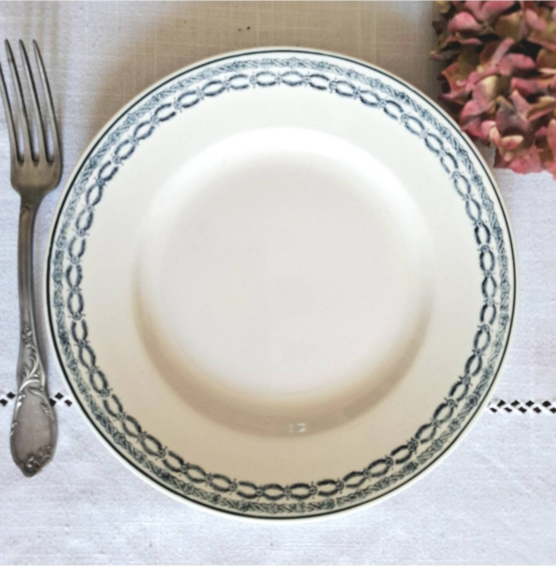 Old mismatched flat plates made of ironstone earthenware.
