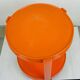 Orange circular plastic cart in Italian Space Age style