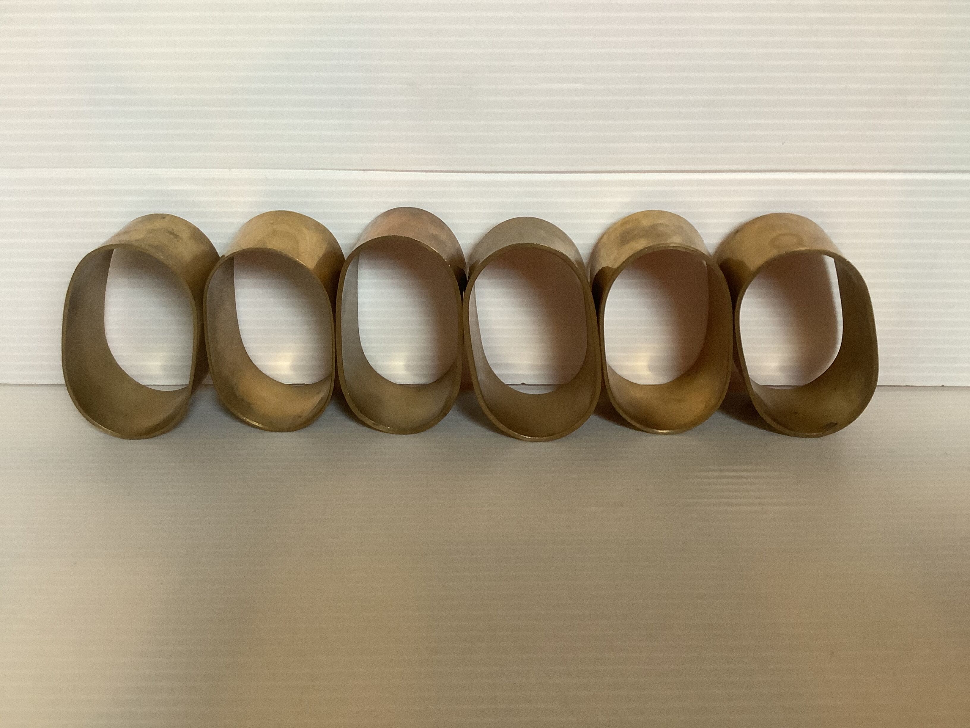 Six old brass napkin rings