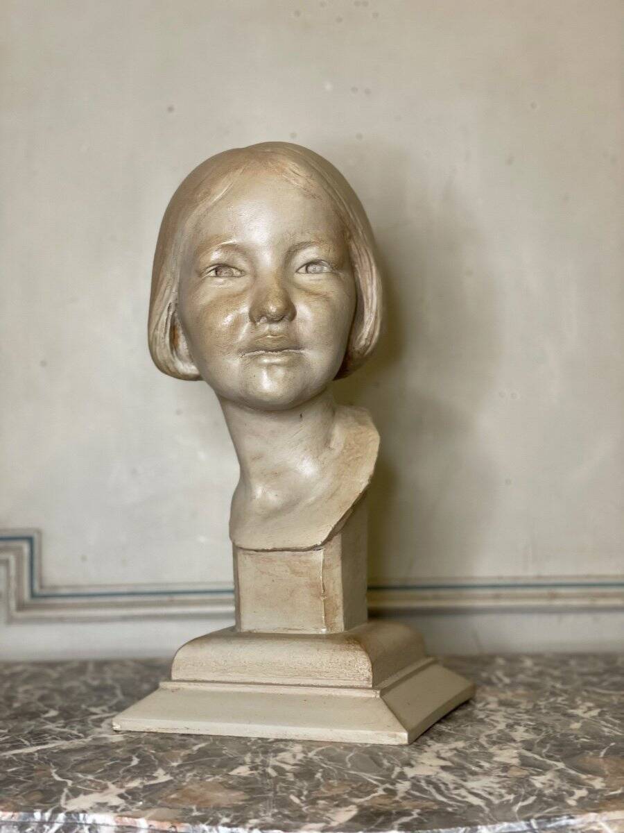 Plaster bust, young girl, monogram and date.