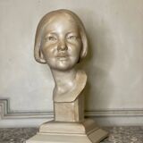 Plaster bust, young girl, monogram and date.