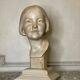 Plaster bust, young girl, monogram and date.