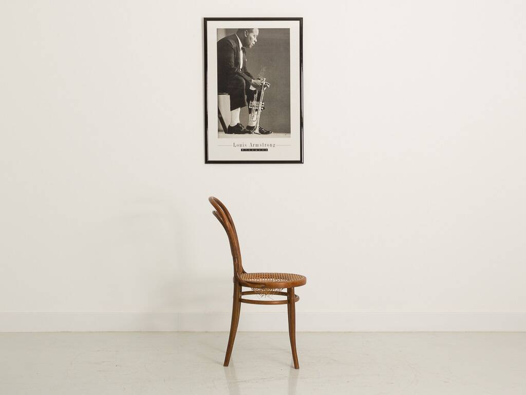 Bistro chair with curved wooden armrests and canning seat