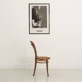 Bistro chair with curved wooden armrests and canning seat