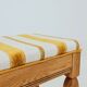 Vintage oak bench with striped linen fabric in a country style.