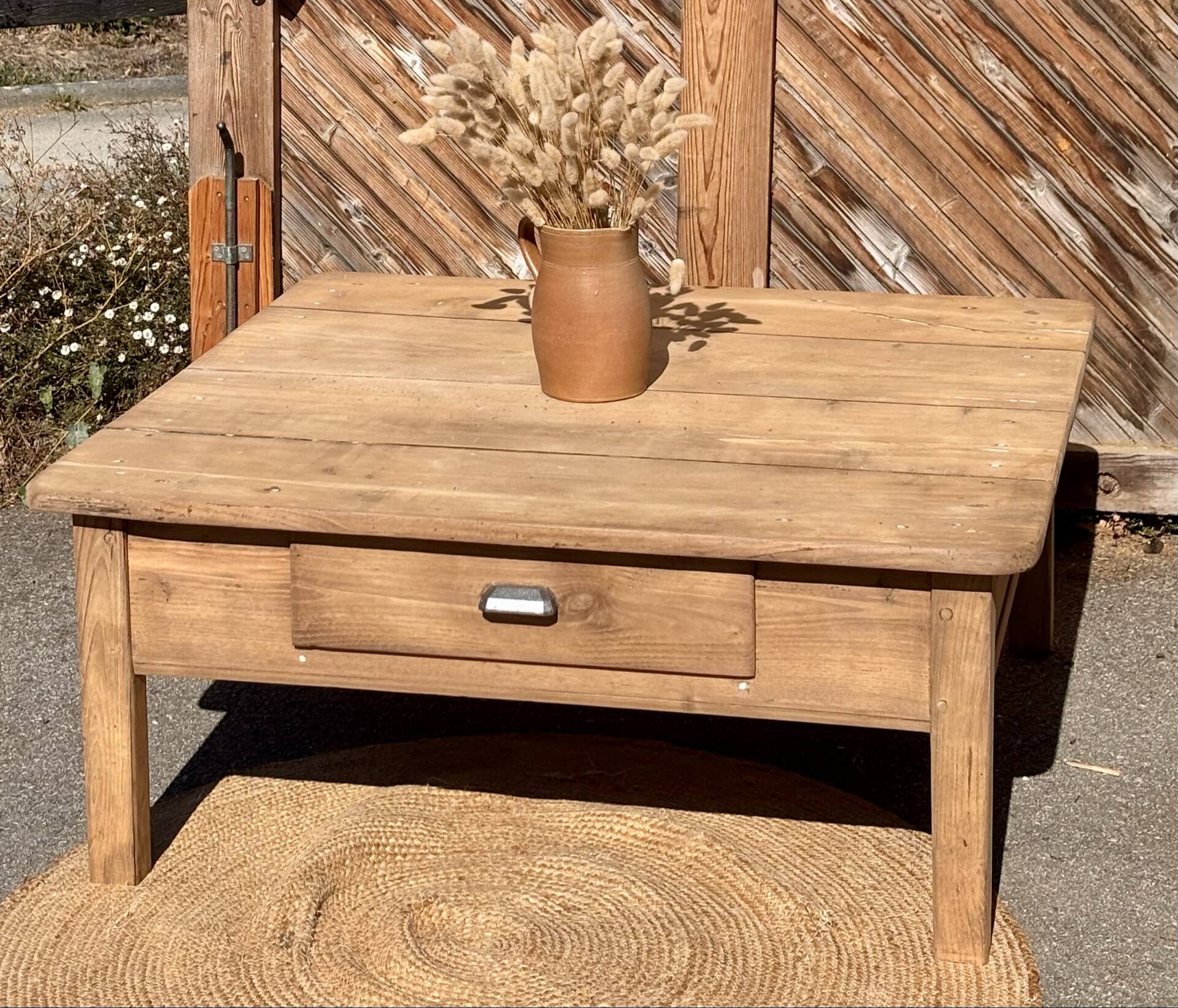 Large square farmhouse coffee table made of raw solid oak.