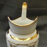 Milk jug or antique pitcher in white and gold porcelain.