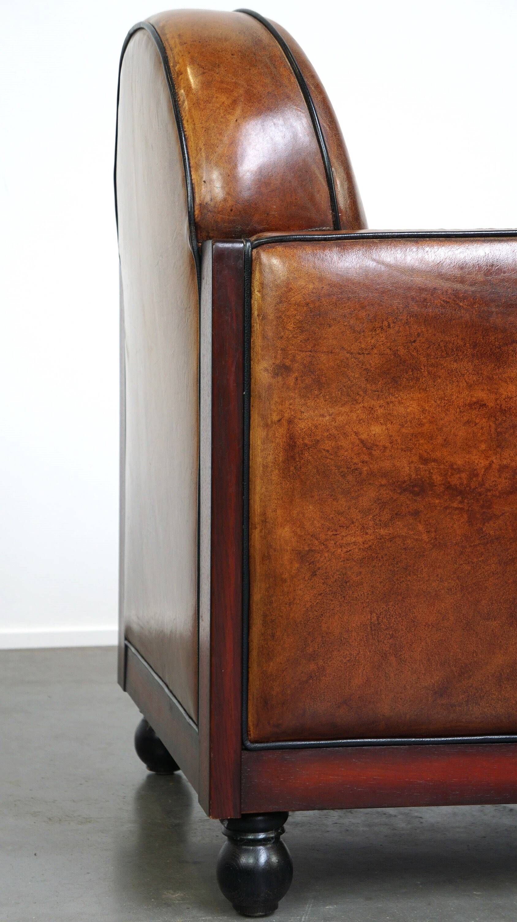 Sheepskin Art Deco design armchair with wood and beautiful cognac-colored leather