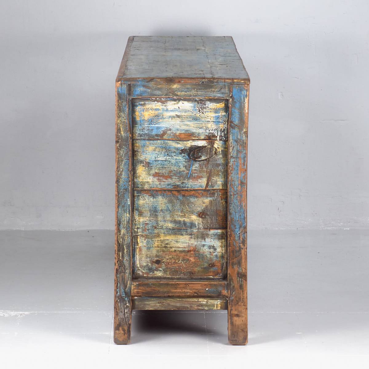 Old wooden entrance buffet in blue and yellow tones (circa 1920).