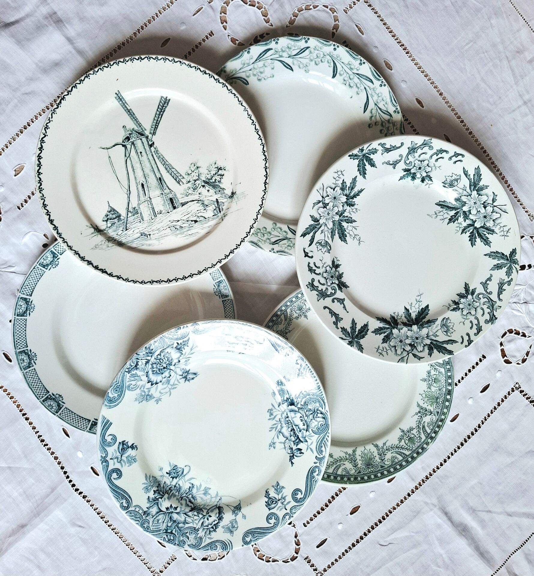Old mismatched flat plates made of ironstone earthenware.