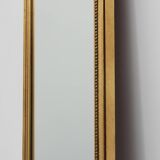 20th Century gilded wooden Empire style mirror with eagle on top