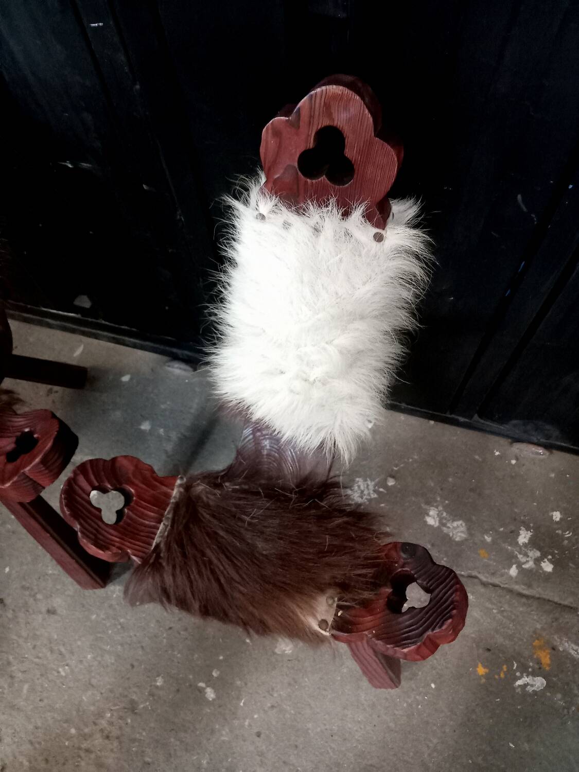 Pair of brutalist tripod chairs in wood and cowhide