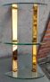 Wall shelf in gilded metal and glass/1980s