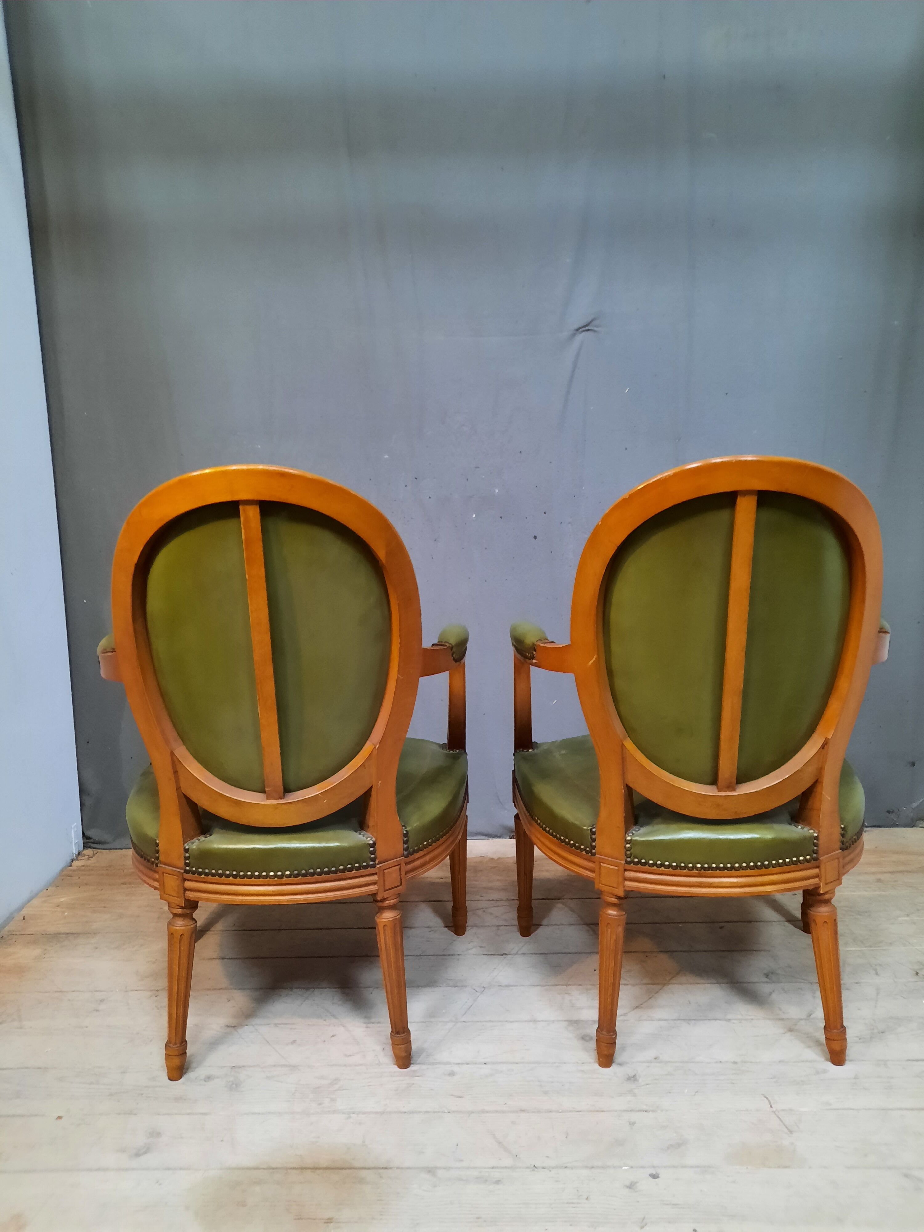 Pair of Louis XVI style leather armchairs