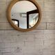 Vintage 1950s round wall mirror, wooden frame and mirror, yellow finish.